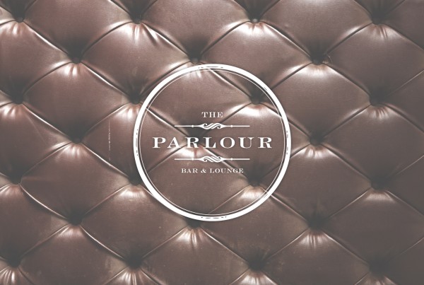 the parlour circle vintage logo on tufted brown leather image, bar and lounge, las vegas nevada, logo design, upscale bar, luxurious leather club chairs